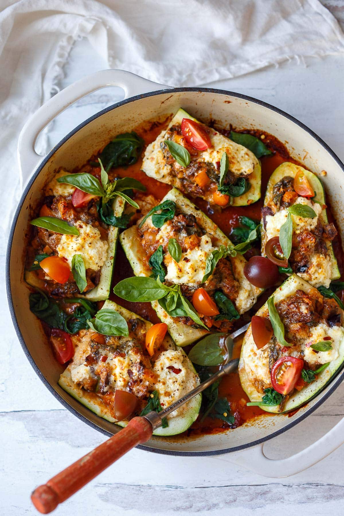 Stuffed Zucchini boats in a braiser.