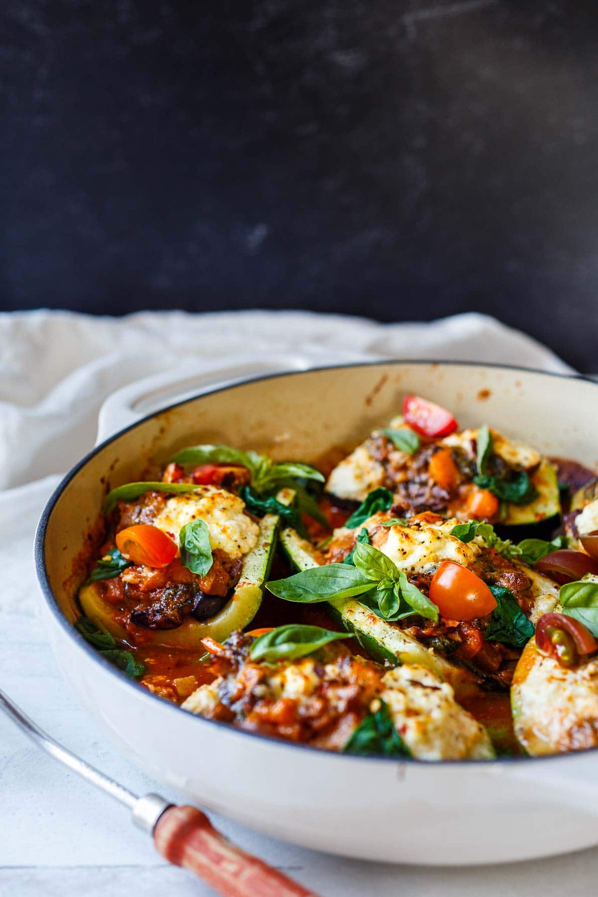 Finished photo of stuffed zucchini boats with basil.
